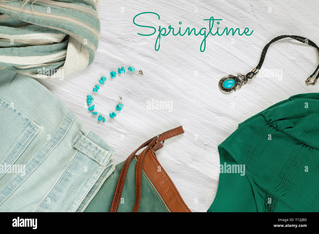 Set of women's clothing - jeans, blouse, scarf, leather cross body bag,  accessories and Springtime text on a white limed background. Spring female  clo Stock Photo - Alamy
