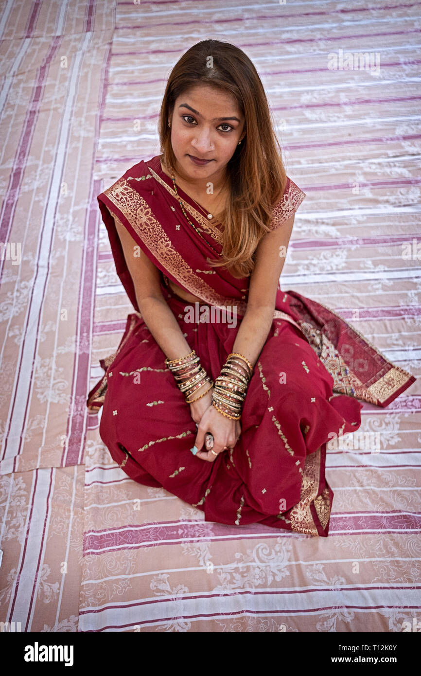 Posed portrait of an attractive Hindu woman in a sari taken at a temple in South Richmond Hill, Queens, New York City. Stock Photo