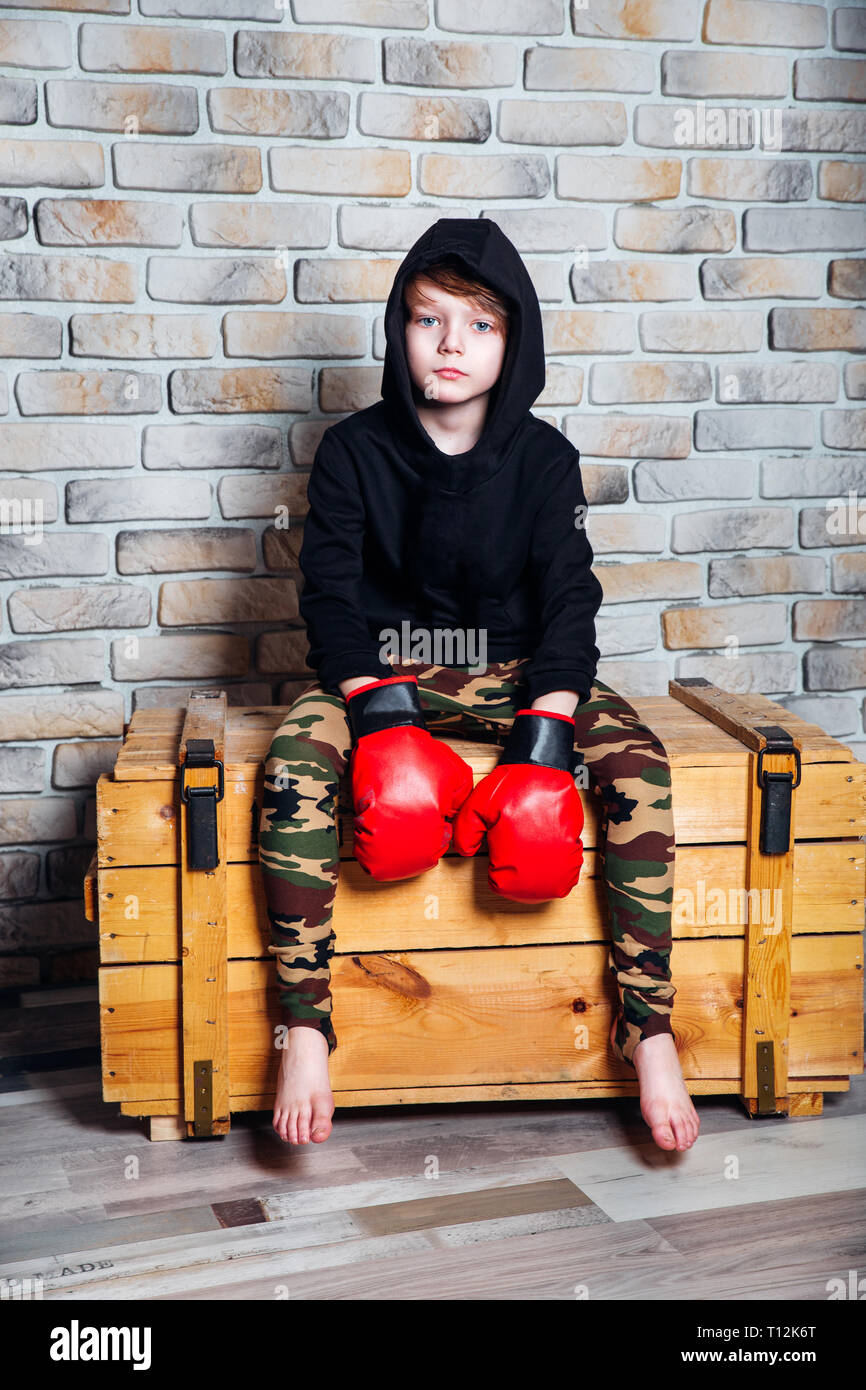 Young boxer .Little boy boxer with blonde hair dressing in black