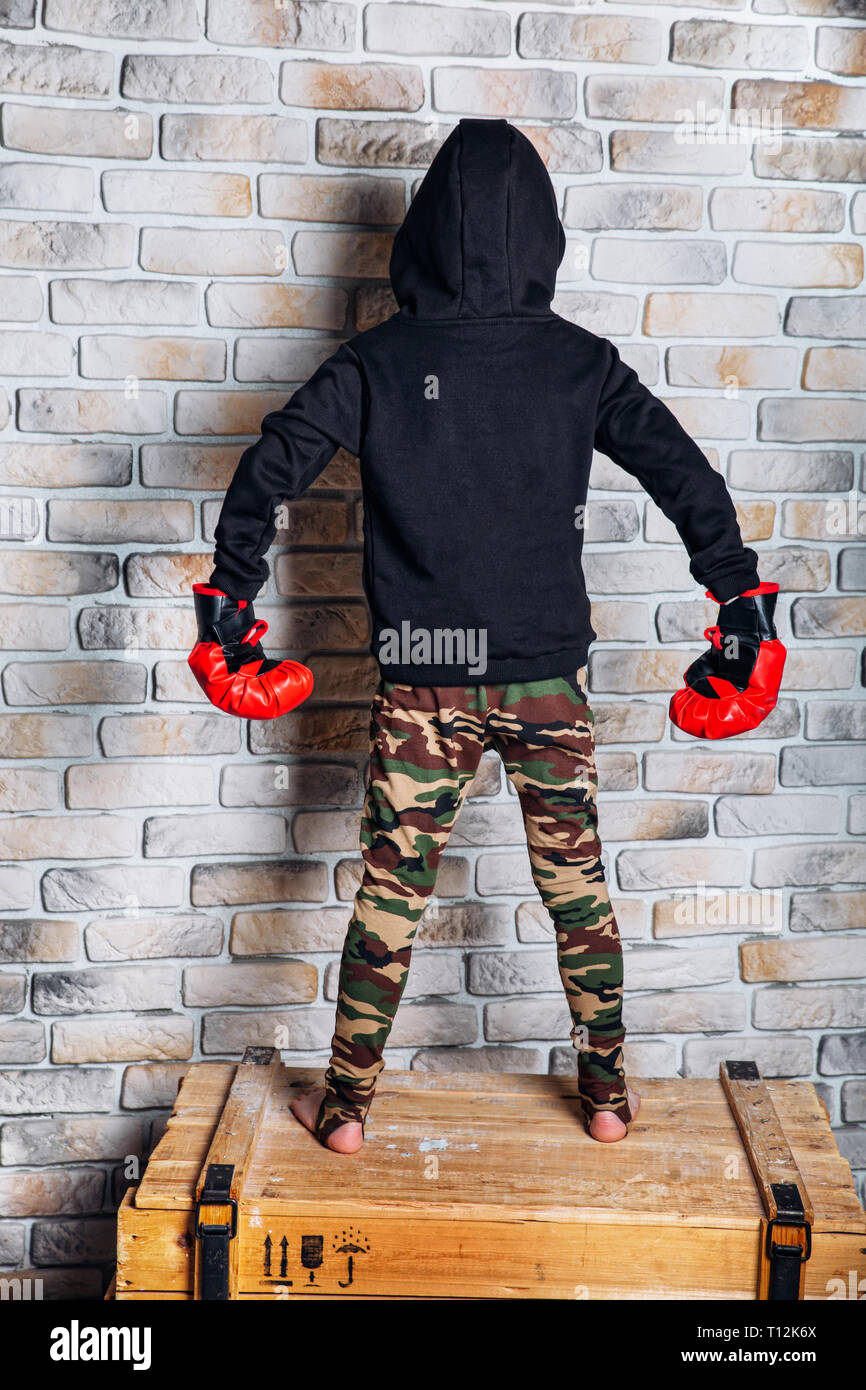 Young boxer .Little boy boxer with blonde hair dressing in black
