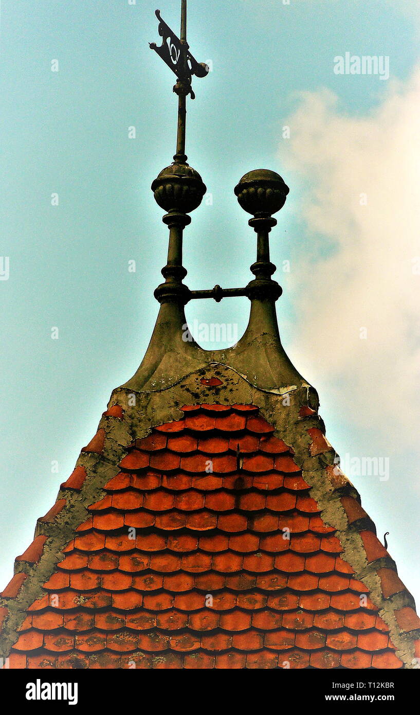 Tower top with red roof tiles and blue sky Stock Photo
