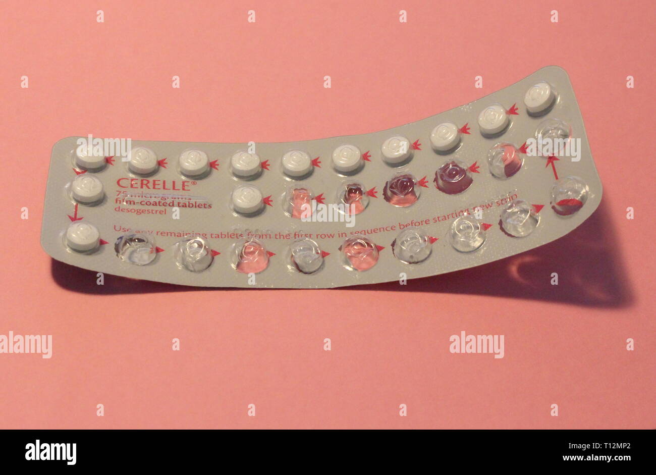 A close up photograph of a half-used contraceptive pill packet against a  baby pink color background. Feminine health and gender concept Stock Photo  - Alamy