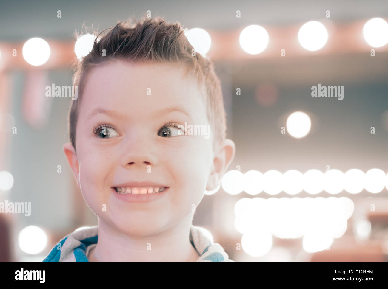 Small happy caucasian boy is smiling after hair cut Stock Photo