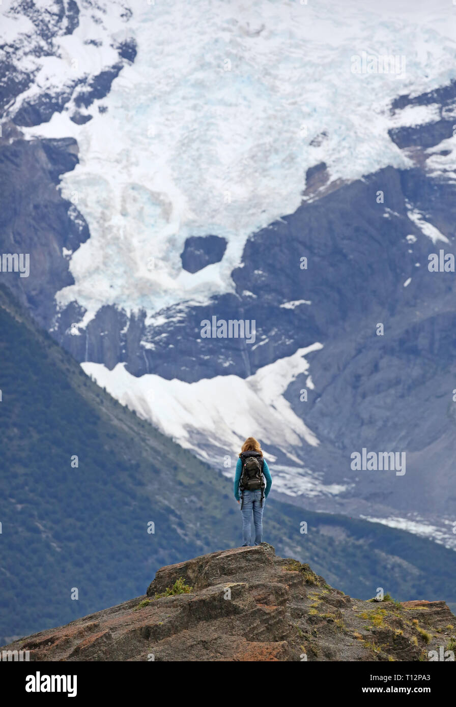 Young women in front of Glaciar Torres - Torres del Paine N.P. (Patagonia, Chile) Stock Photo