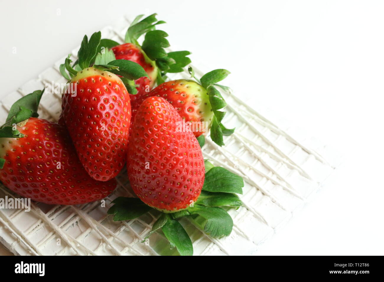Fresh strawberries with sugar on white background Stock Photo - Alamy