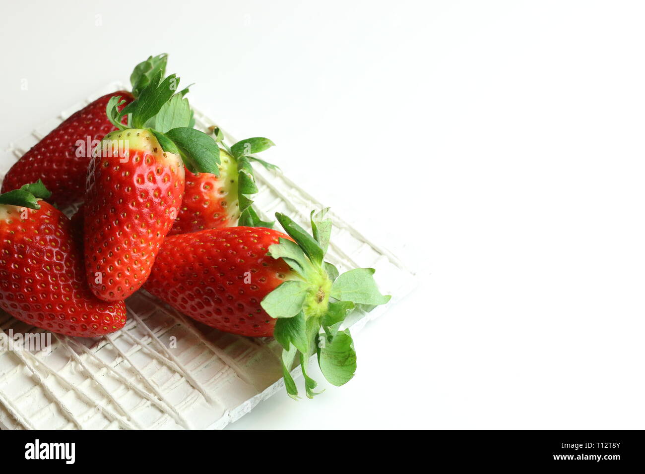 Fresh strawberries with sugar on white background Stock Photo - Alamy