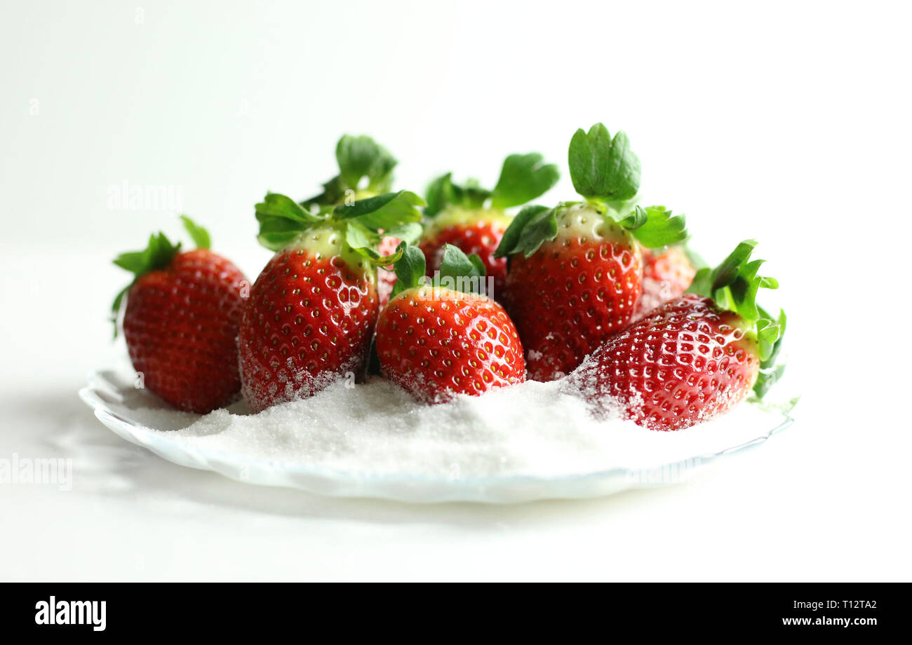 Fresh strawberries with sugar on white background Stock Photo - Alamy