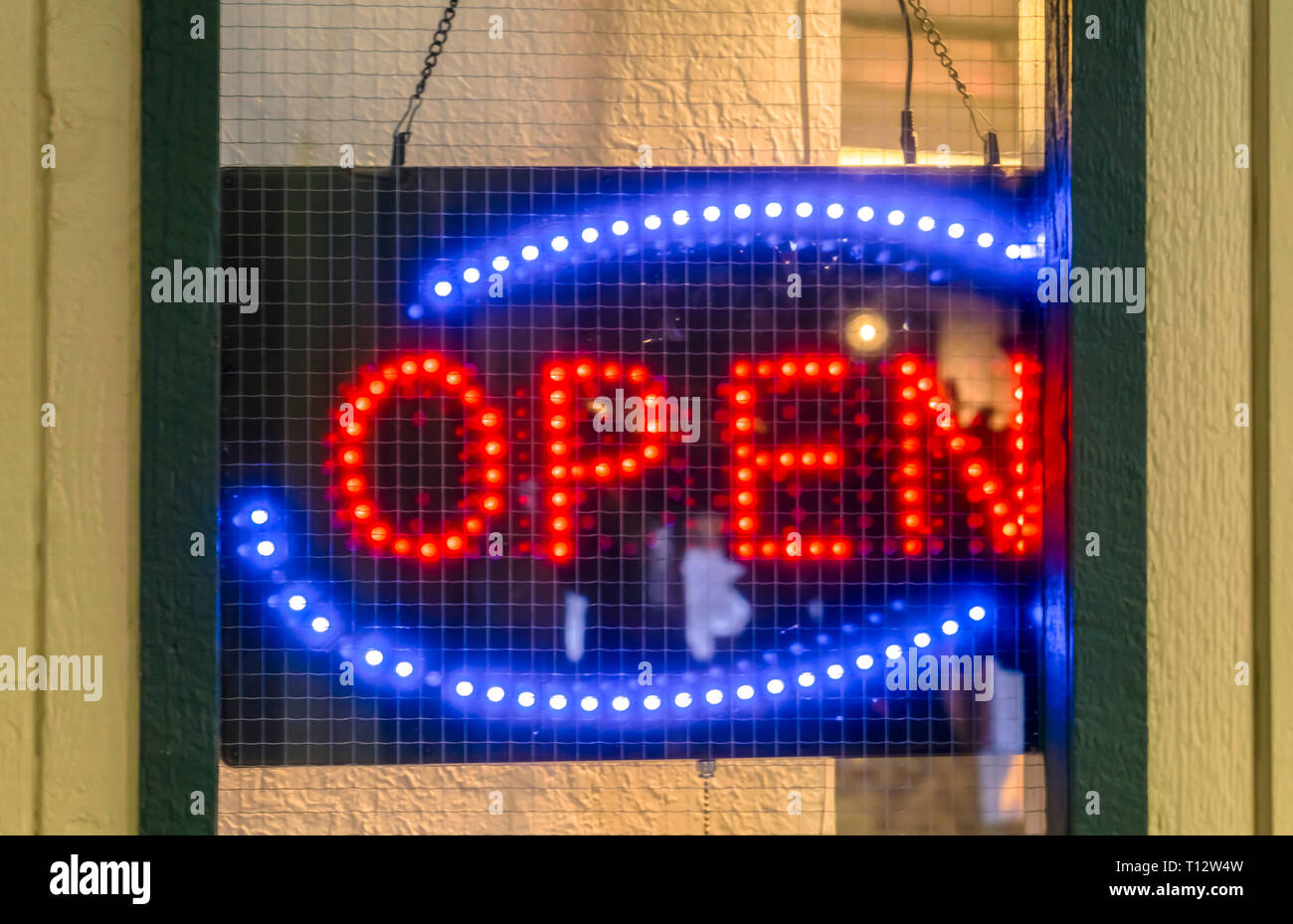 Neon Open Sign On The Door Of An Establishment Close Up Of A Red And Blue