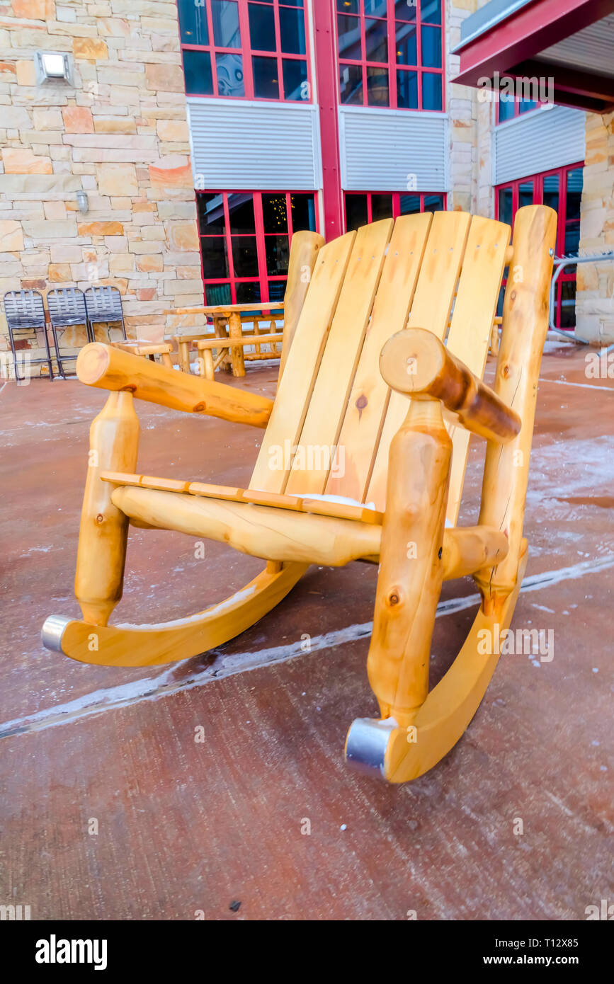 Wooden Rocking Chair On The Patio Of A Building Stock Photo