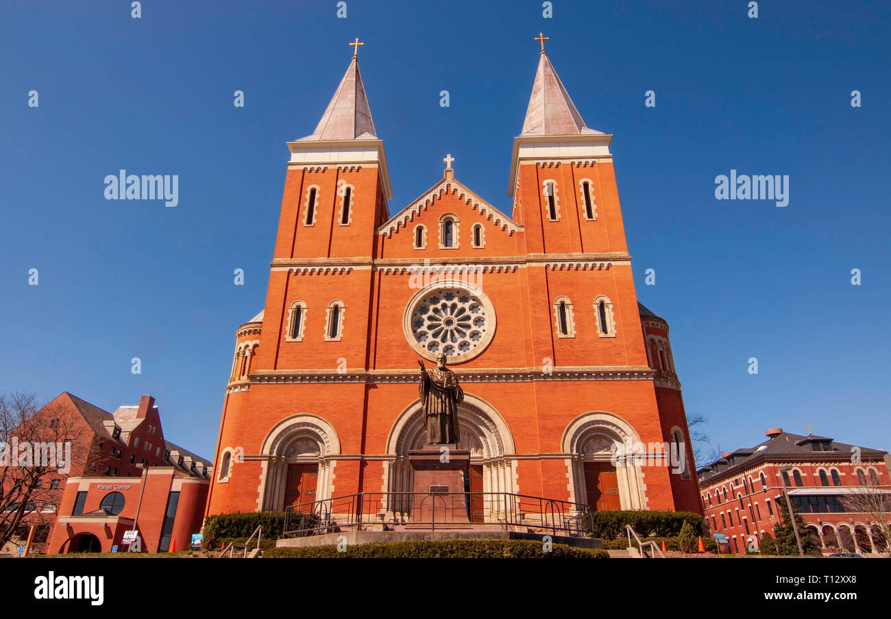 St Vincent Basilica, a Catholic church on the campus of St Vincent College with a bronze statue of St Vincent in front of it in Latrobe, PA, USA Stock Photo