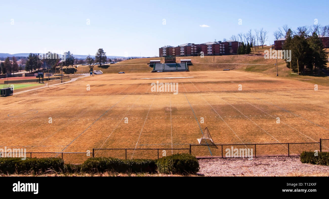 The brown, dead grass in spring on the Chuck Noll football field at St Vincent University where the Pittsburgh Steelers hold summer camp. Stock Photo