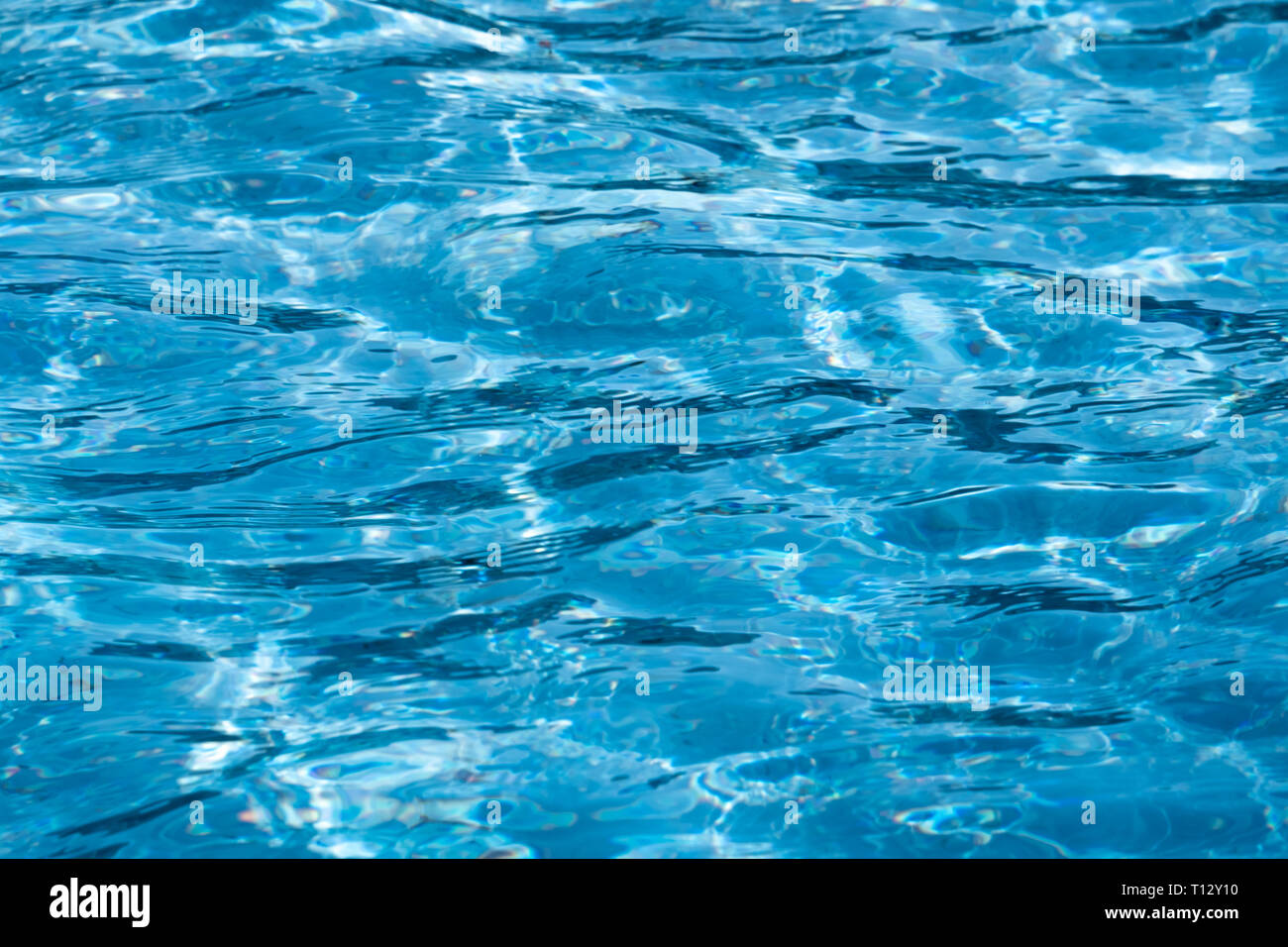 Blue and bright ripple clean water surface in swimming pool with sun ...
