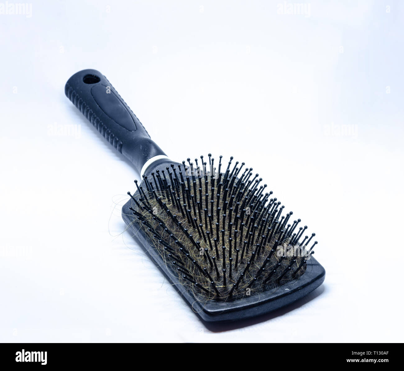 Close up view of a hair brush with hair Stock Photo