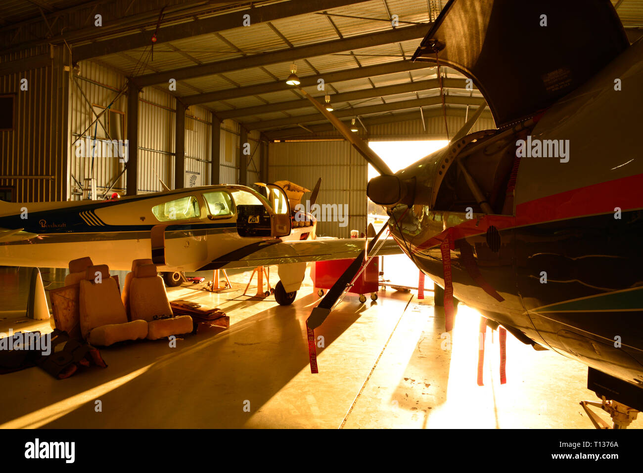 Aircraft maintenance hangar with sunlight illuminating the building interior. Stock Photo