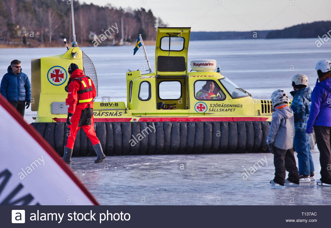 Covered hovercraft and crew of the Swedish Sea Rescue Society on the ice of Lake Malaren, Sigtuna, Sweden, Scandinavia Stock Photo