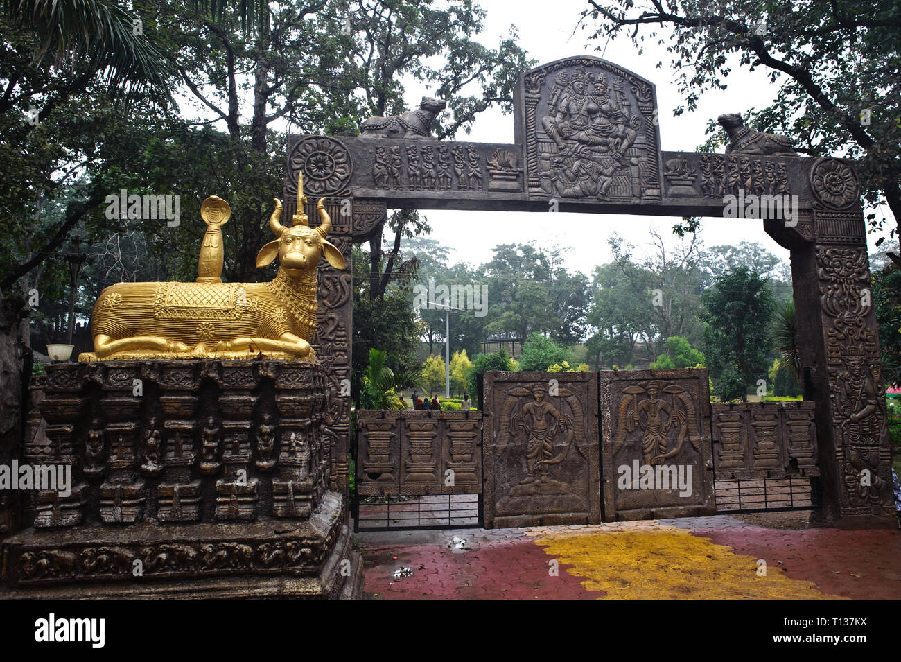 Entrance of a public park  ( India) The golden sculpture is representing the bull Nandi, the mount of the hindu god Shiva. Stock Photo