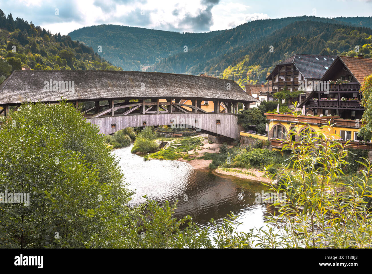 historical wooden covered bridge over the river Murg, landmark of village Forbach, Northern Black Forest, Germany, Murg valley Stock Photo
