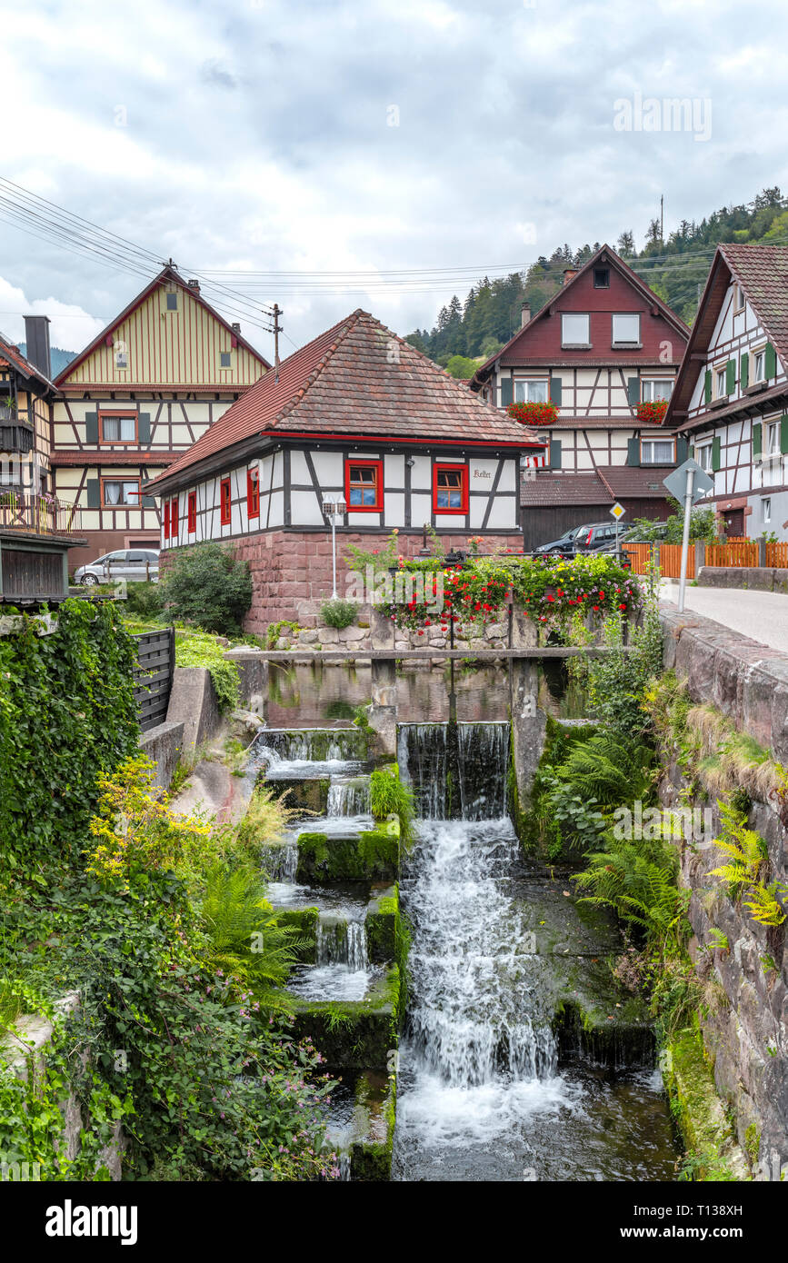 half-timbered houses and brook with waterfall in the Murg valley of the Northern Black Forest, Germany, village Reichenbach, town Gernsbach Stock Photo