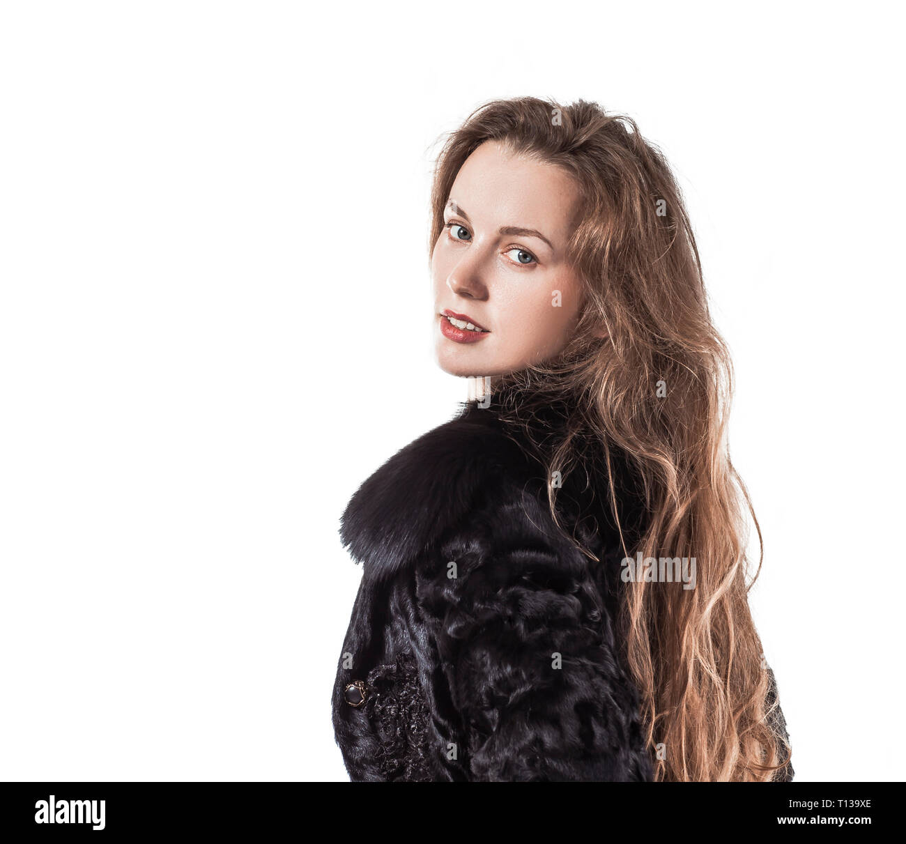 portrait of young business woman in a black coat on a white background ...