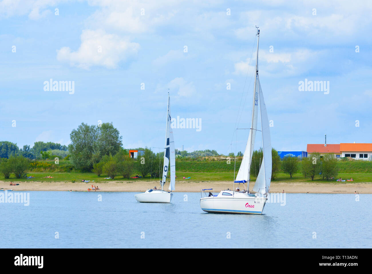 Yachts sailing at local recreation area pensinsual sea called Kollersee in Brühl in Germany Stock Photo