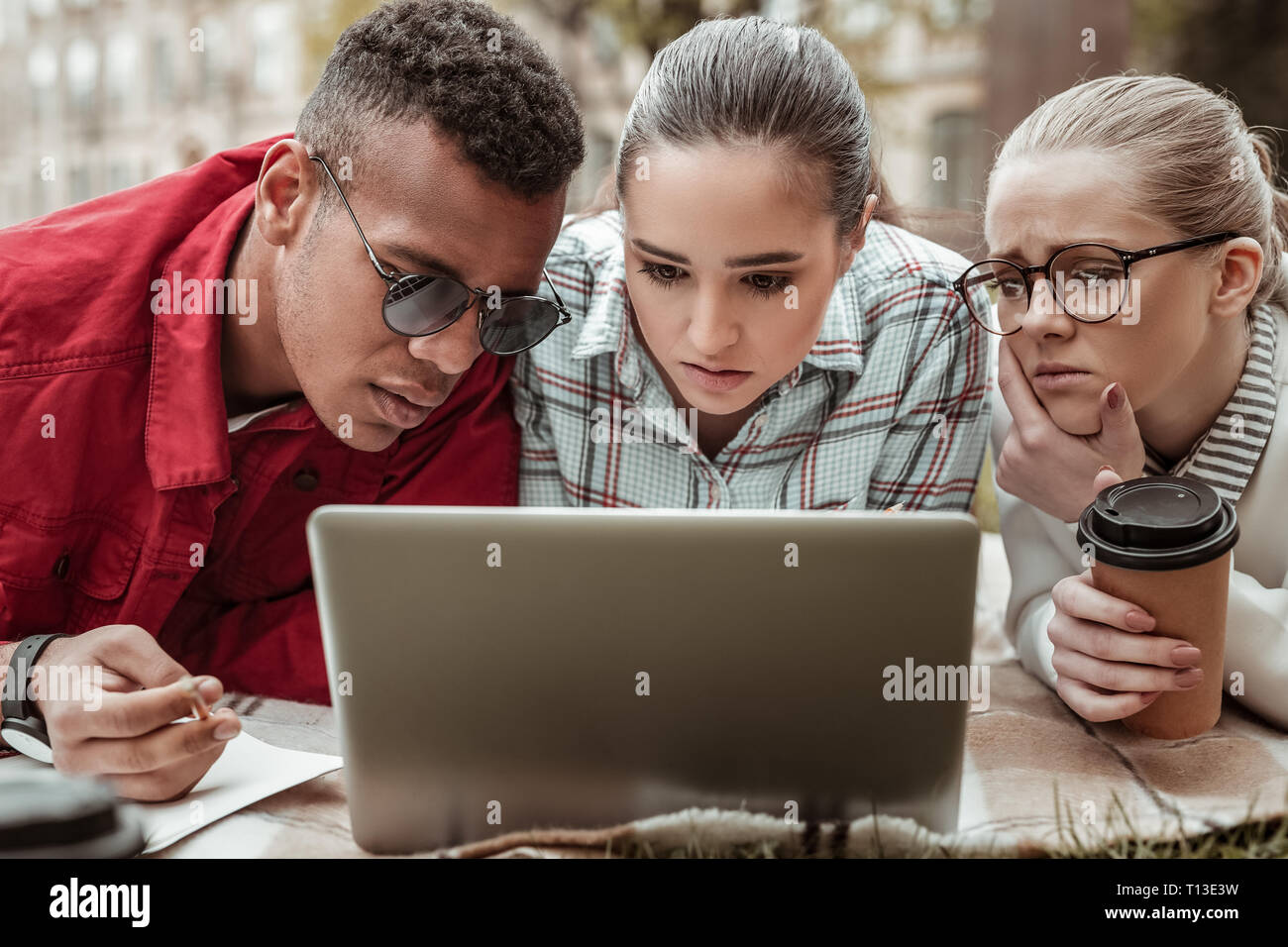 Attentive group mates starting at their gadget Stock Photo