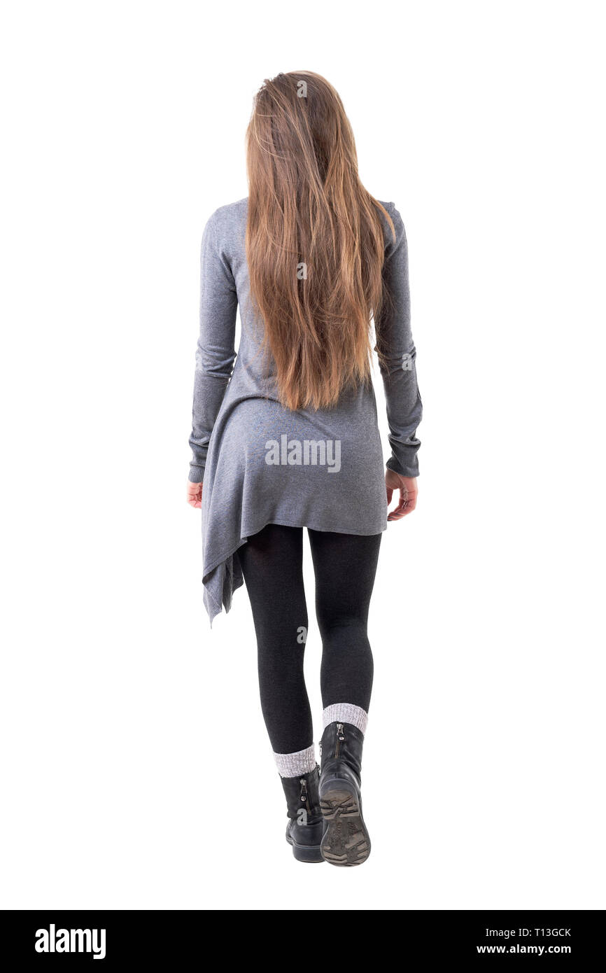 Back view of young stylish woman with long healthy hair walking away. Full body isolated on white background. Stock Photo