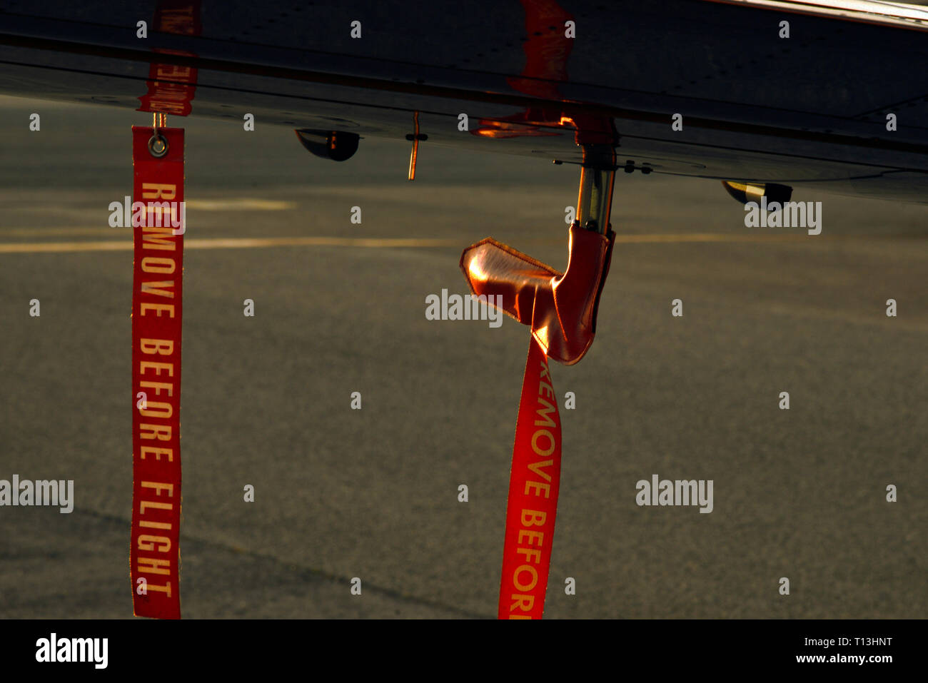'Remove before flight' securing tags on an aircraft.One of them covers the pitot tube. Stock Photo