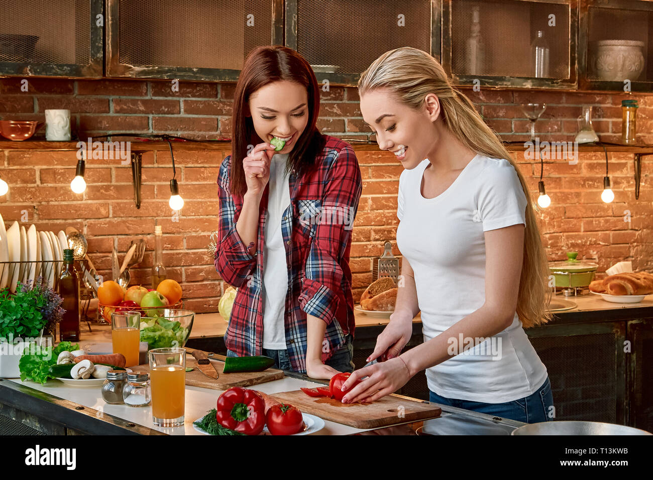 Slice and dice. an attractive young woman chopping vegetables in a kitchen  Stock Photo - Alamy
