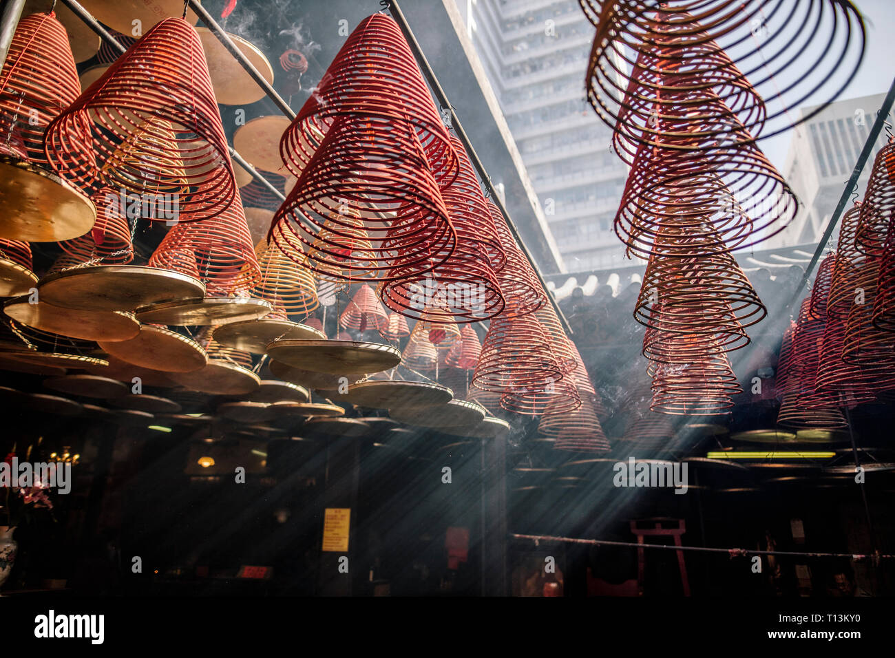 Hong Kong, Yau Ma Tei, Tin Hau Temple, incense spirals in light beam Stock Photo