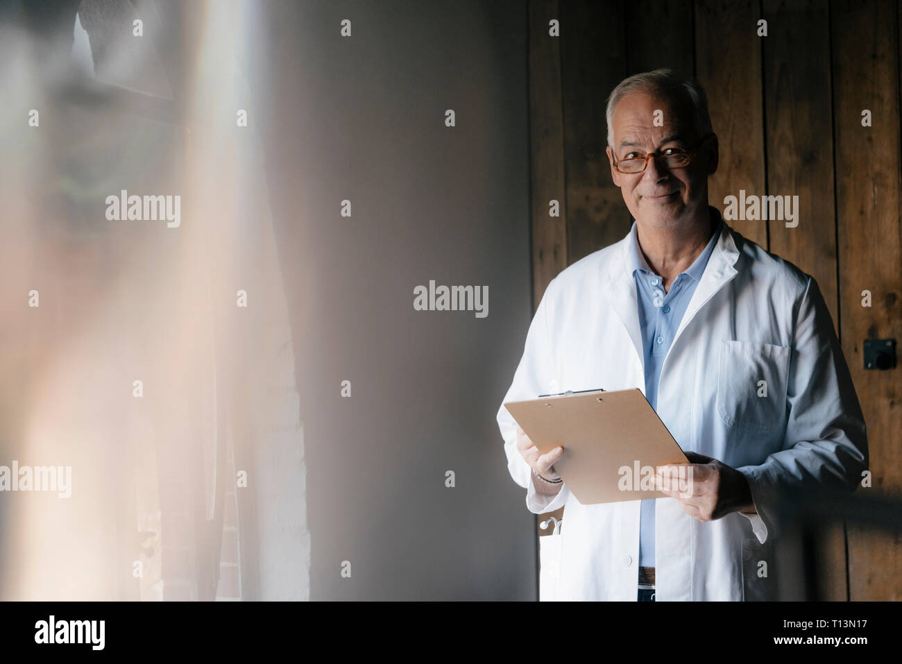 Doctor smiling holding clipboard hi-res stock photography and images ...