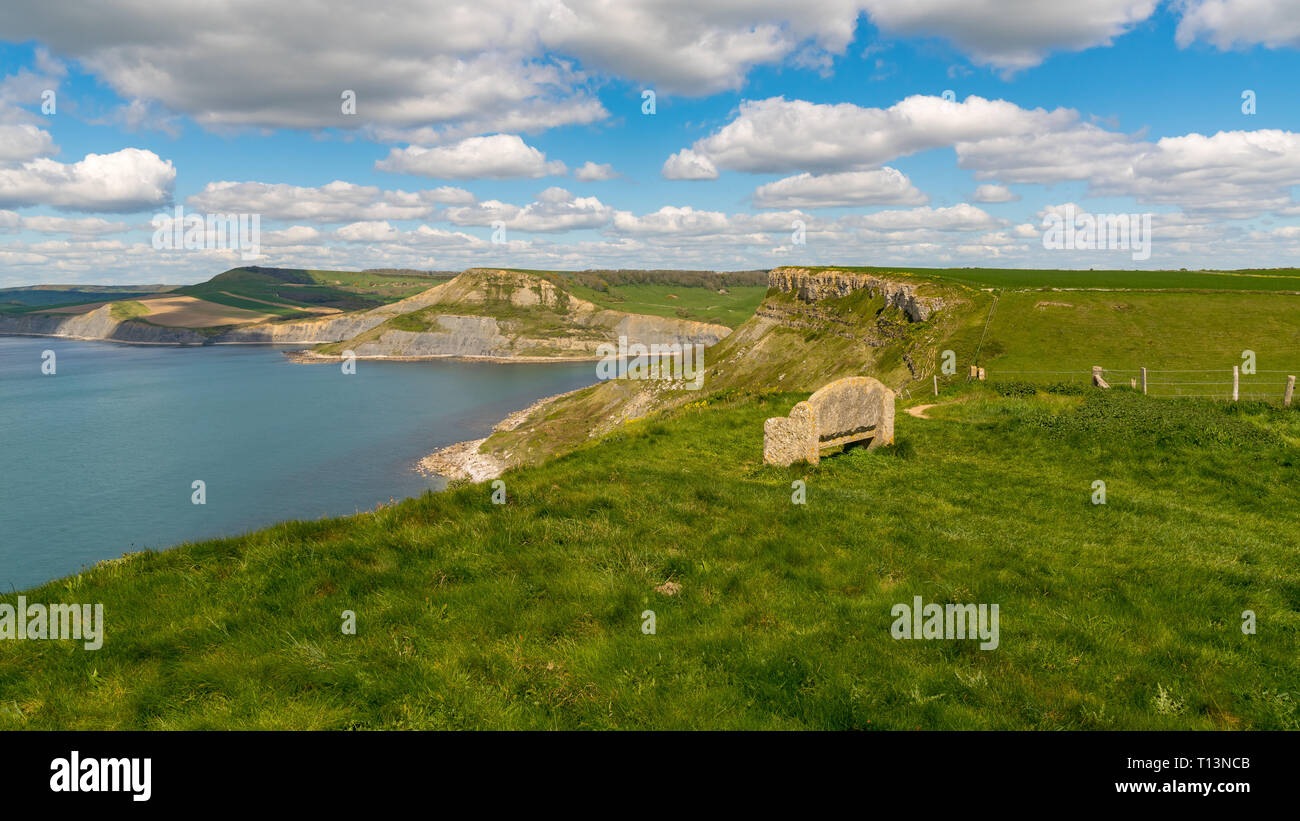Stone bench at the South West Coast Path with a view over the Jurassic Coast and Emmett's Hill, near Worth Matravers, Jurassic Coast, Dorset, UK Stock Photo