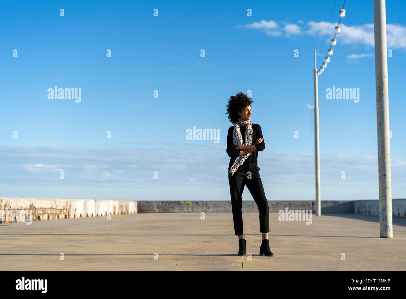Woman dressed in black enjoying sunlight Stock Photo
