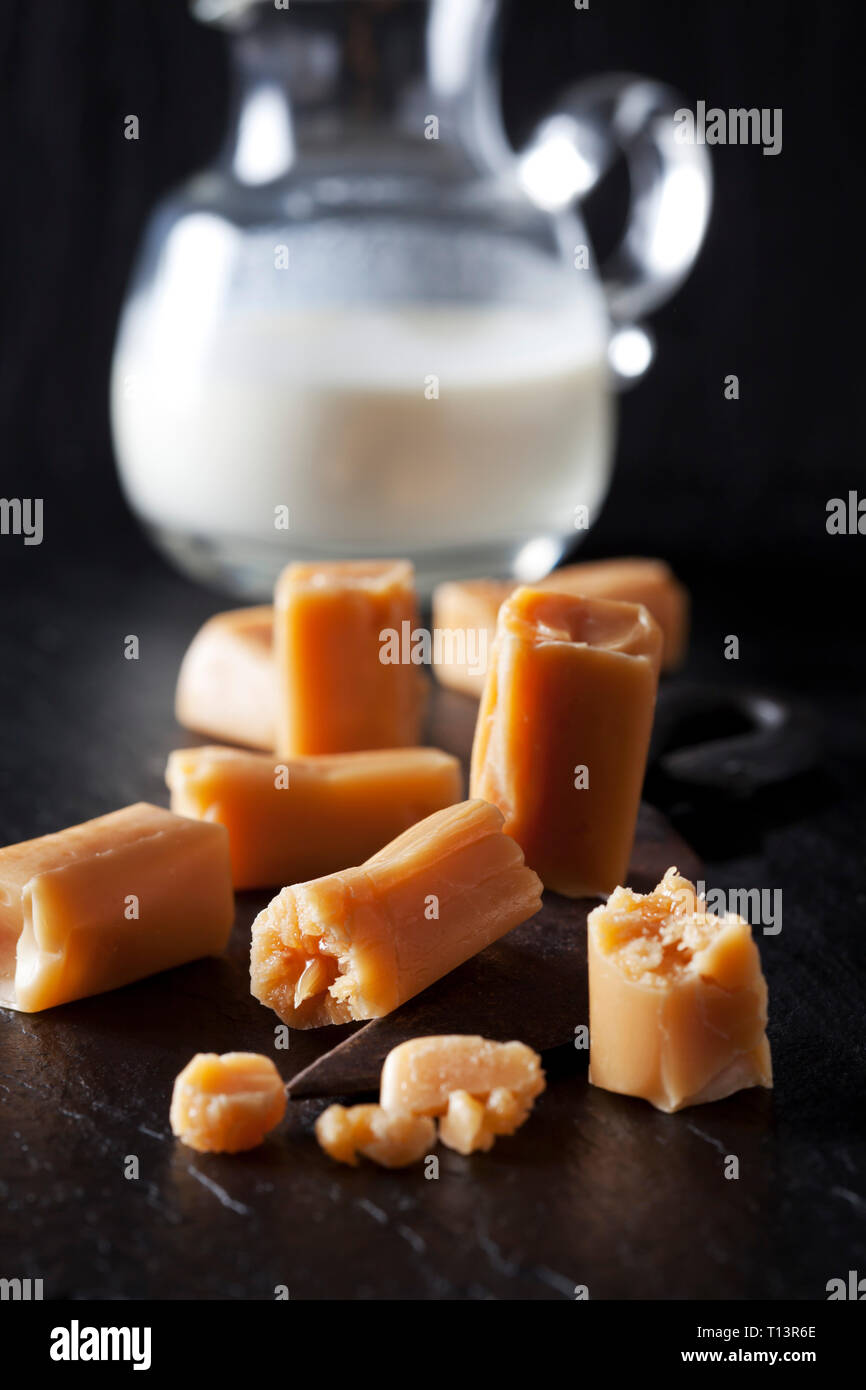 Fresh cream toffees and a carafe of cream Stock Photo