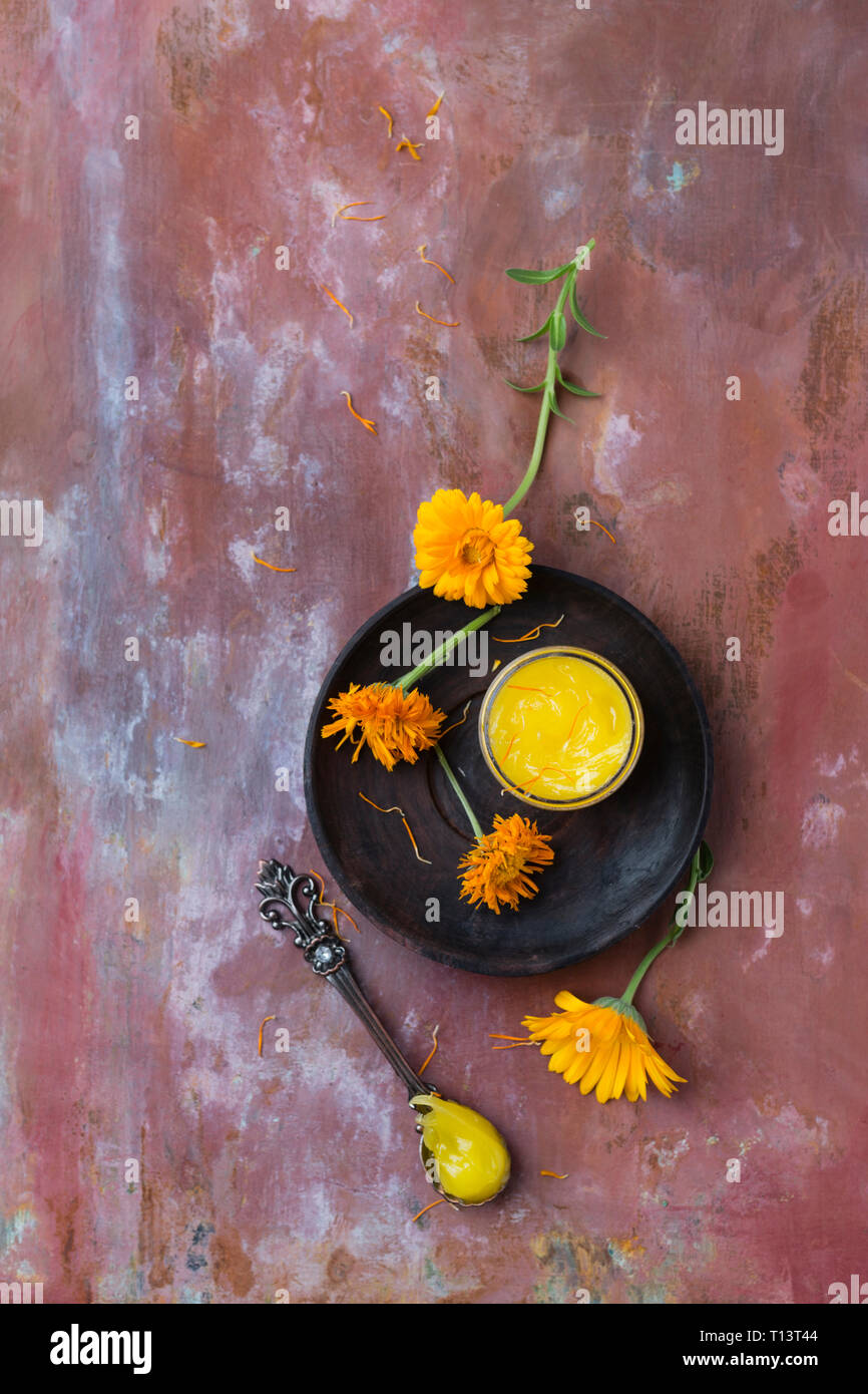Dried marigold blossoms and marigold salve Stock Photo