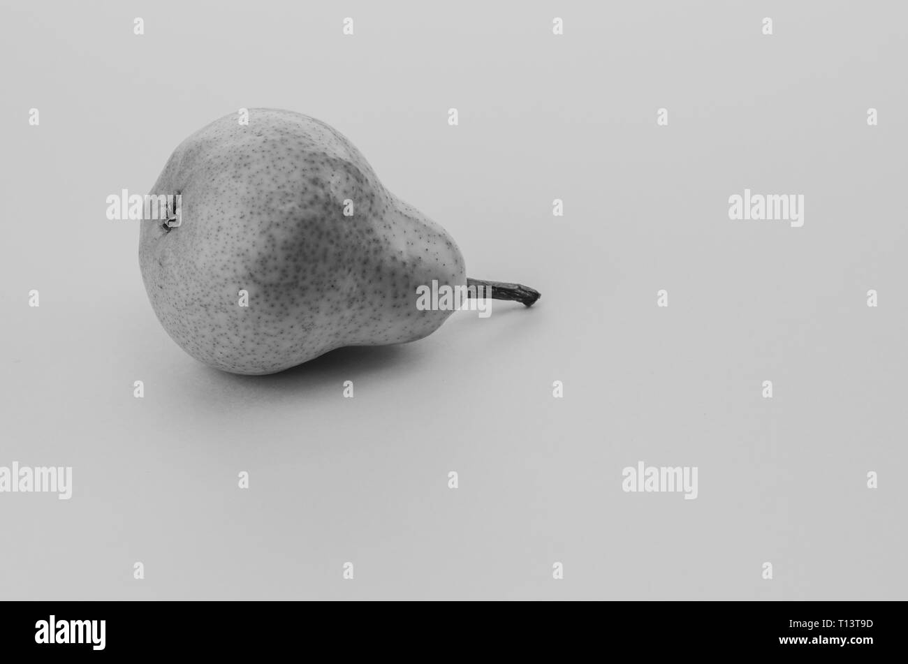 ripe pear fruit on a blank surface surface - black and white image Stock Photo