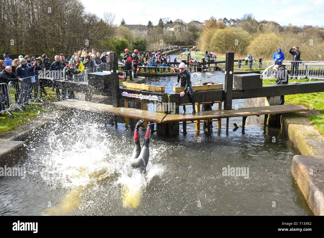 Maryhill, Glasgow, Scotland, UK. 23rd Mar, 2019. uk weather - determined competitors braving 8 degree water temperatures at the Red Bull Neptune Steps swim/climb adventure race at Maryhill Locks, Glasgow. The annual extreme event involves swimming 400 m of cold water and climbing 18 metres over 7 canal lock gates Credit: Kay Roxby/Alamy Live News Stock Photo