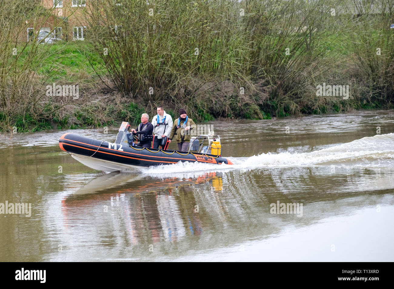 Minsterworth, Gloucestershire, UK. 23rd Mar 2019. Rigid inflatable boats surf the Severn Bore on the river Severn in Gloucesteshire. Stock Photo