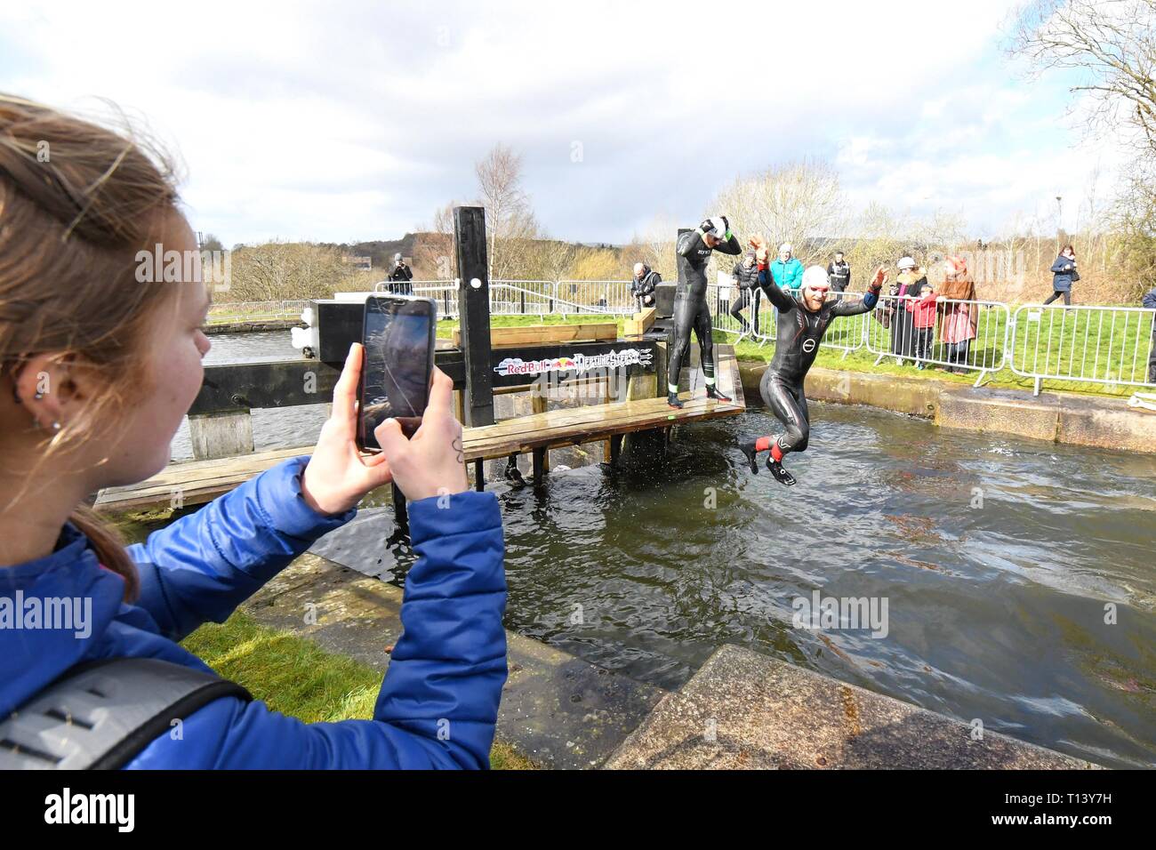 Maryhill, Glasgow, Scotland, UK. 23rd Mar, 2019. uk weather - determined competitors braving 8 degree water temperatures at the Red Bull Neptune Steps swim/climb adventure race at Maryhill Locks, Glasgow. The annual extreme event involves swimming 400 m of cold water and climbing 18 metres over 7 canal lock gates Credit: Kay Roxby/Alamy Live News Stock Photo