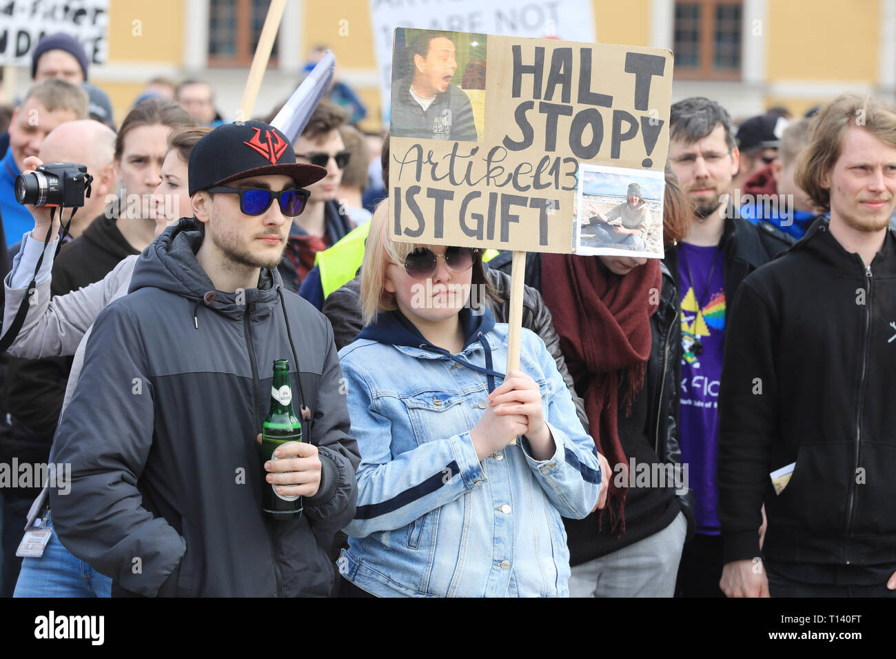 Magdeburg, Germany. 23rd Mar, 2019. "Stop Stop, Article 13 is poison" is written on a poster that a young woman is holding under the motto "Save the Internet" at the demonstration against upload filters on the occasion of the planned EU copyright reform. Shortly before the decisive vote on the reform of copyright in the EU Parliament, thousands in Europe protested against the project. Opponents of the reform and especially of the controversial Article 13 had announced demonstrations in about 20 countries. Credit: Peter Gercke/dpa-Zentralbild/dpa/Alamy Live News Stock Photo