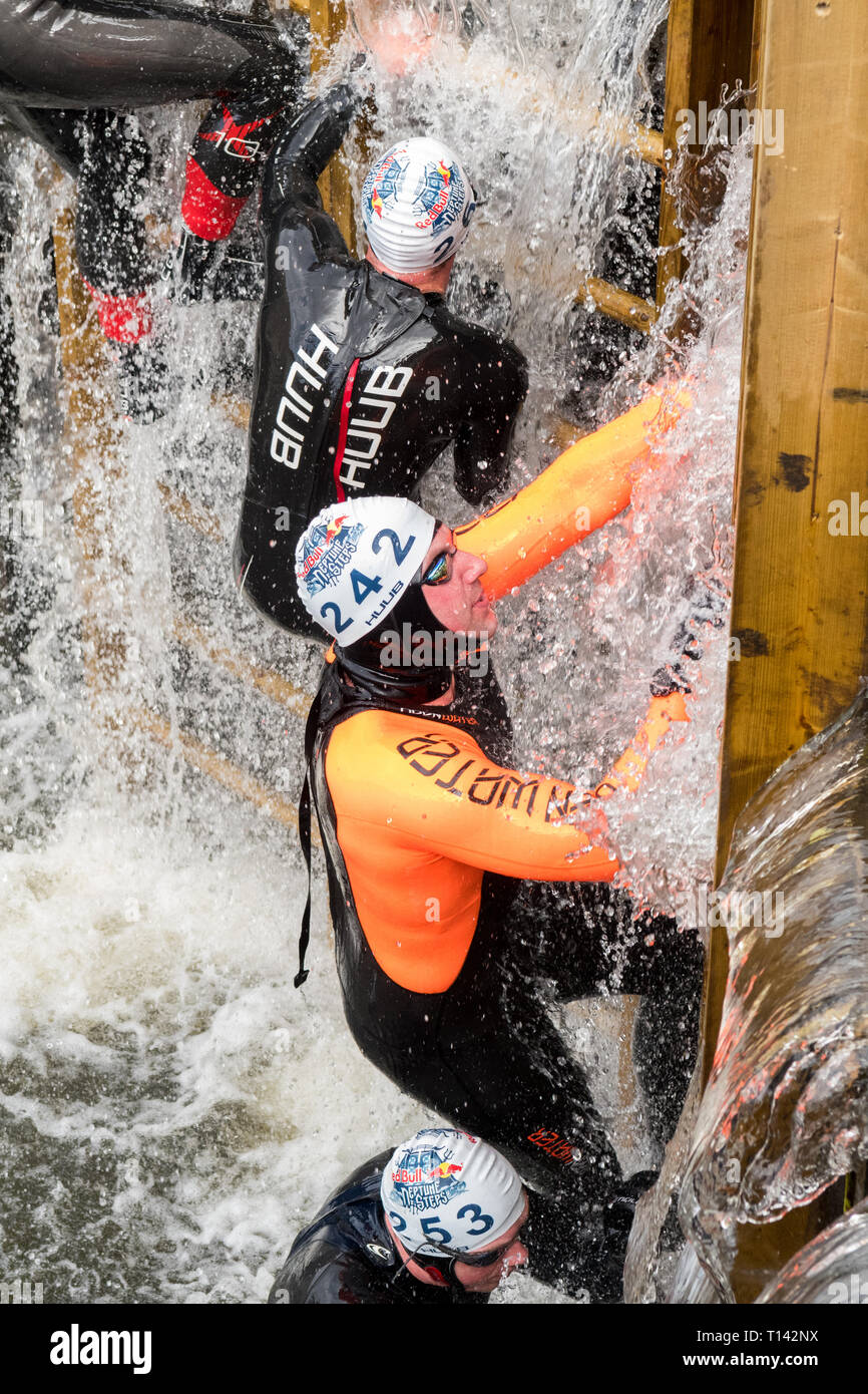 Maryhill, Glasgow, Scotland, UK. 23rd Mar, 2019. UK weather - determined competitors braving 8 degree water temperatures at the Red Bull Neptune Steps swim/climb adventure endurance race at Maryhill Locks, Glasgow. The annual extreme event involves swimming 400m of cold canal water and climbing 18 metres over 7 canal lock gate obstacles Credit: Kay Roxby/Alamy Live News Credit: Kay Roxby/Alamy Live News Stock Photo
