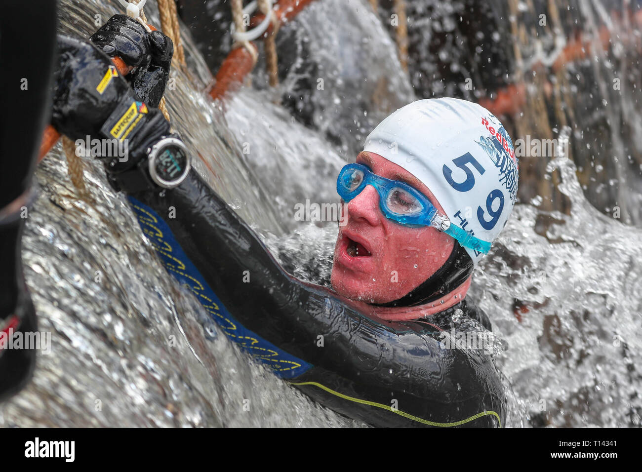 Glasgow, Scotland, UK. 23rd March, 2019. 600 hundred international competitors took part in the annual Red Bull Neptune Steps Cold Water race along 5 locks of the Clyde and Forth Canal at Maryhill, known as Neptune Steps, Glasgow, UK. Thee competitors had to swim the canal, climb ropes and specially constructed obstacle walls to complete the course in water temperatures of up to 8 degrees centigrade. Credit: Findlay/Alamy Live News Stock Photo