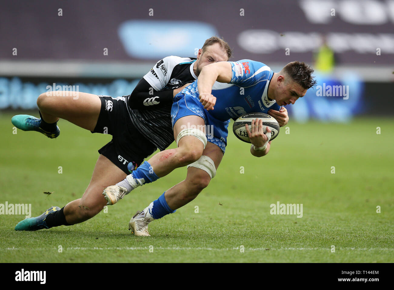Swansea,  UK. 23rd Mar, 2019. Taine Basham of the Dragons is tackled by Cory allen of the Ospreys. Guinness Pro14 rugby match, Ospreys v Dragons at the Liberty Stadium in SSwansea,  South Wales on Saturday 23rd March 2019. pic by Andrew Orchard, Andrew Orchard sports photography/Alamy Live News. Stock Photo
