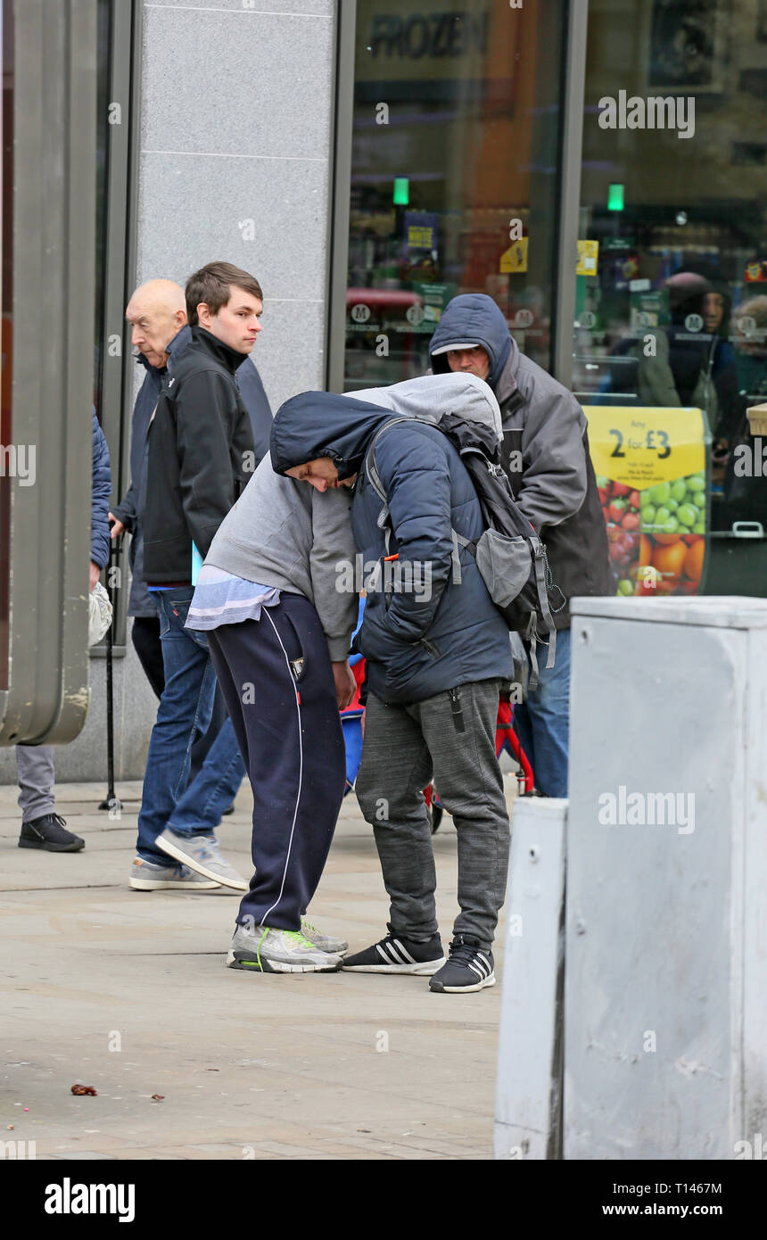 Manchester, UK. 23rd March, 2019. Police Officers assist two men who