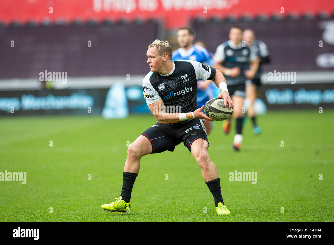 Liberty Stadium, Swansea, Wales, UK. Saturday 23 March 2019. Ospreys right wing Hanno Dirksen passes the ball in in the Guinness Pro14 rugby match between Ospreys and Dragons. Credit: Gruffydd Thomas/Alamy Live News Stock Photo