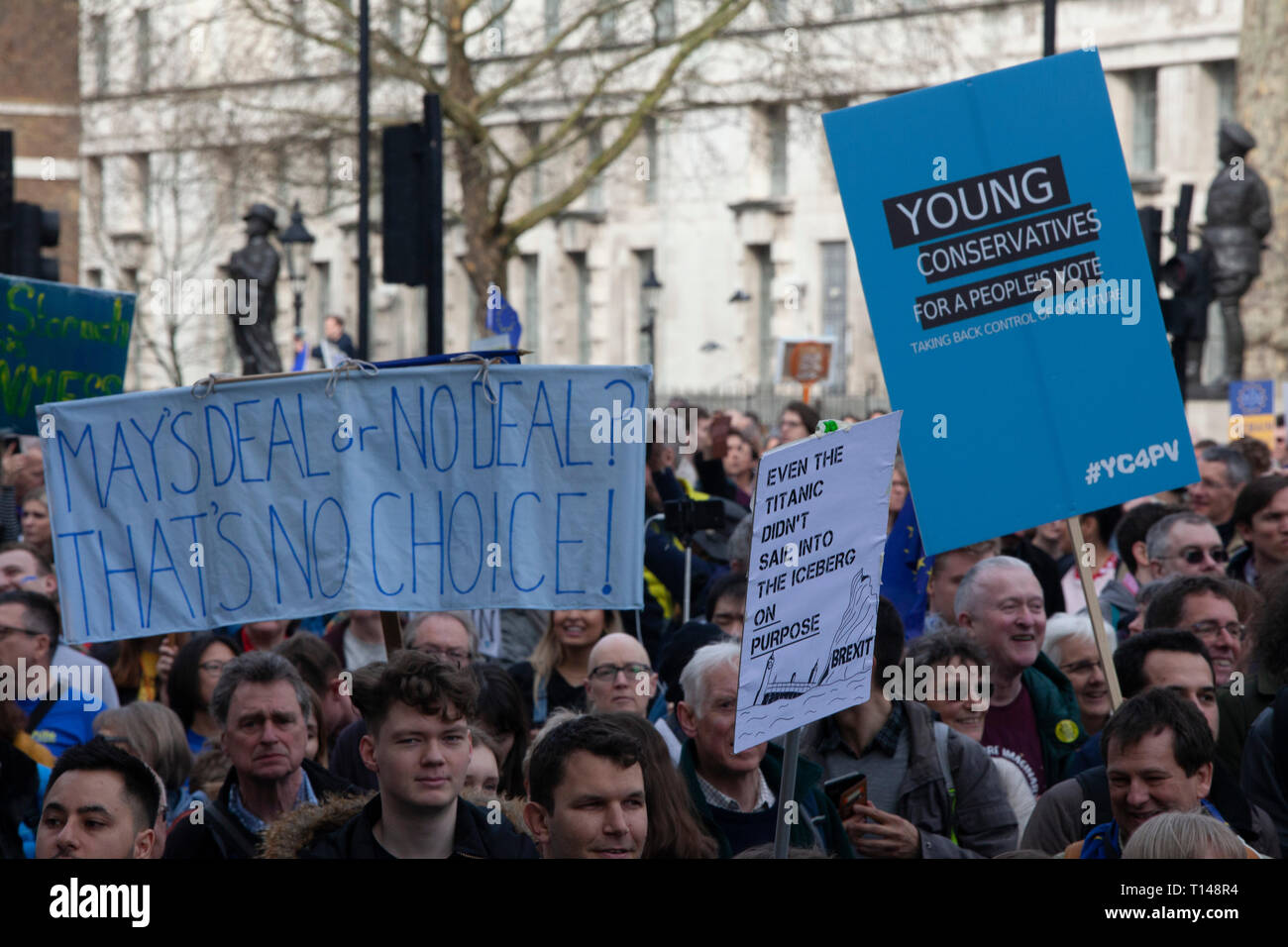 London, UK. 23rd March, 2019.  The Put it to the People March in London: people with home-made placards callling for a People's Vote march past the gates of Downing Street on Whitehall. Credit: Anna Watson/Alamy Live News Stock Photo