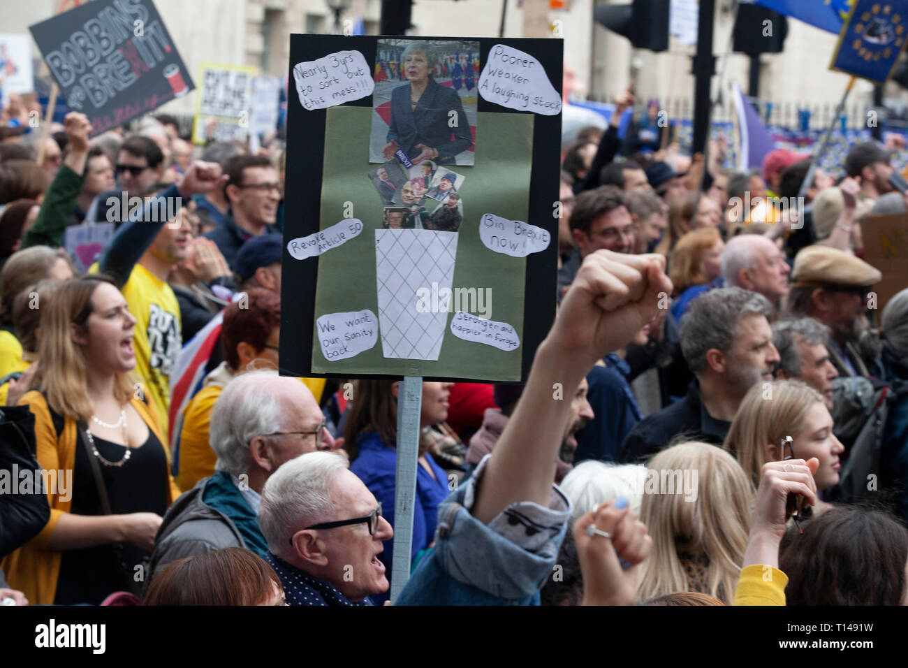 London, UK. 23rd March, 2019.  The Put it to the People March in London: people with home-made placards callling for a People's Vote march past the gates of Downing Street on Whitehall. Credit: Anna Watson/Alamy Live News Stock Photo
