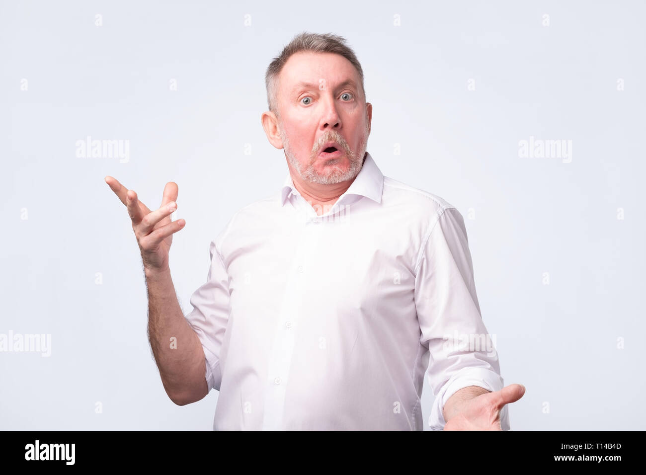 Astonished man trying to argue with his wife Stock Photo - Alamy