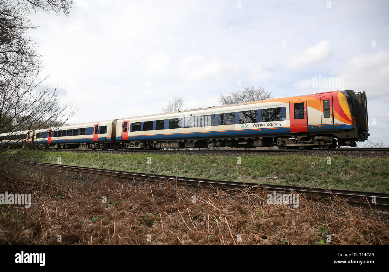 A South Western Railway train makes it's way along the line near to Basingstoke in Hampshire. Stock Photo