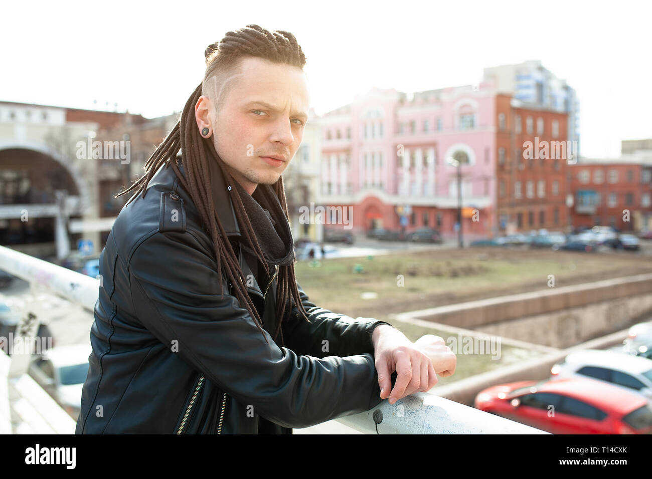 rocker rock star young man walking on the city street autumn day Stock ...