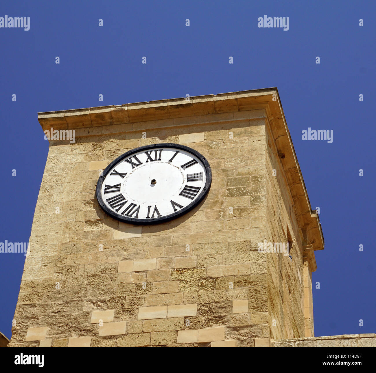 Timeless tower clock without pointer in Malta Stock Photo